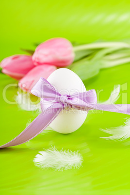 traditional easter egg decoration with tulips and ribbon