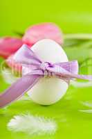 traditional easter egg decoration with tulips and ribbon