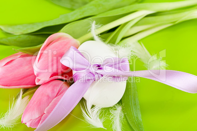 traditional easter egg decoration with tulips and ribbon