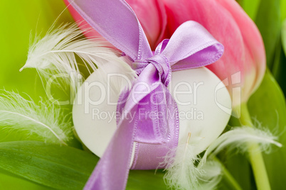 traditional easter egg decoration with tulips and ribbon