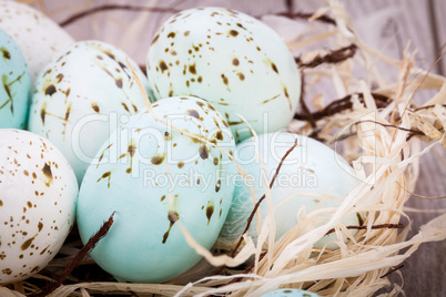 Three natural blue Easter eggs in a basket