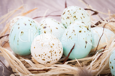 Three natural blue Easter eggs in a basket