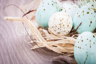 Three natural blue Easter eggs in a basket