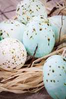 Three natural blue Easter eggs in a basket