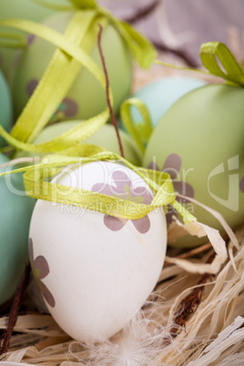 Colourful green Easter eggs in straw