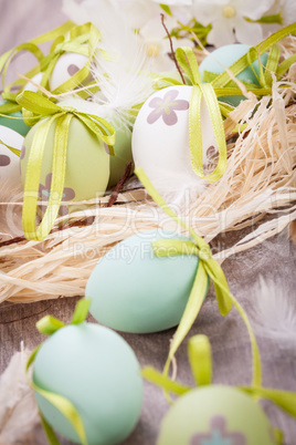 Colourful green Easter eggs in straw