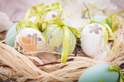 Colourful green Easter eggs in straw