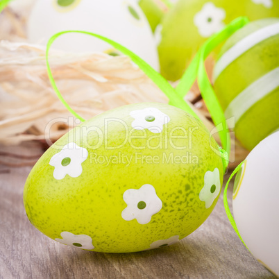 Colourful green Easter eggs in straw