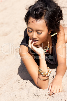 beautiful asian woman with colorful makeup on the beach