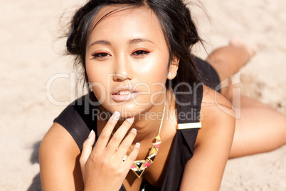 beautiful asian woman with colorful makeup on the beach