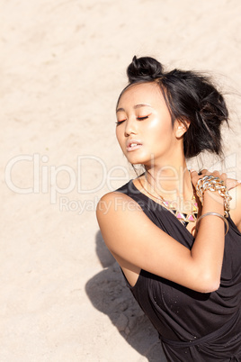 beautiful asian woman with colorful makeup on the beach