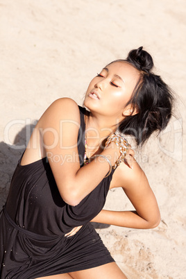 beautiful asian woman with colorful makeup on the beach