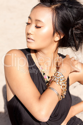 beautiful asian woman with colorful makeup on the beach