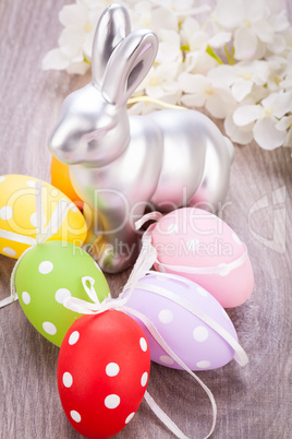 Easter still life with a silver bunny and eggs