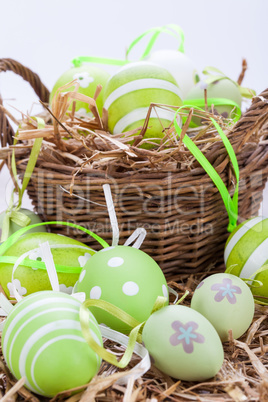 Colourful green Easter eggs in straw