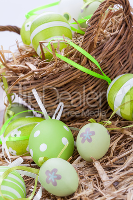 Colourful green Easter eggs in straw