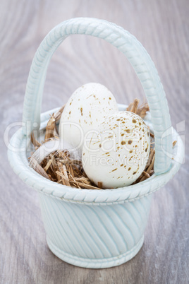 Three natural blue Easter eggs in a basket