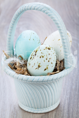 Three natural blue Easter eggs in a basket