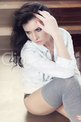 attractive young woman sitting on the floor