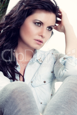 attractive young woman sitting on the floor