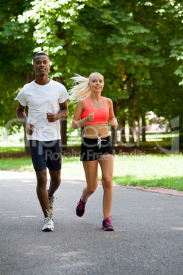 young couple runner jogger in park outdoor summer