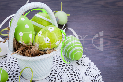 Colourful green Easter eggs in straw