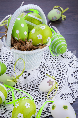 Colourful green Easter eggs in straw