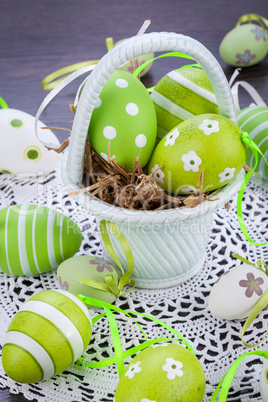 Colourful green Easter eggs in straw