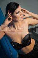 Woman in black lingerie dripping water