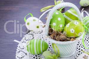 Colourful green Easter eggs in straw