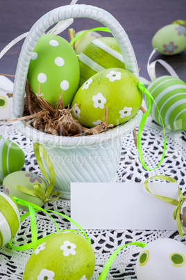 Colourful green Easter eggs in straw