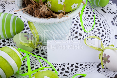 Colourful green Easter eggs in straw