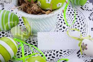 Colourful green Easter eggs in straw