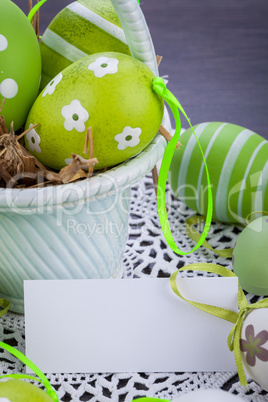 Colourful green Easter eggs in straw