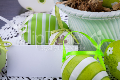 Colourful green Easter eggs in straw