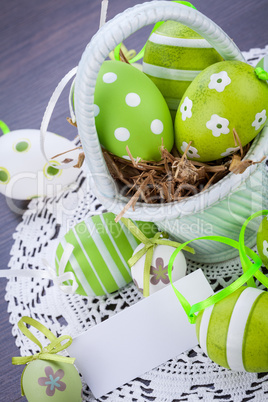 Colourful green Easter eggs in straw