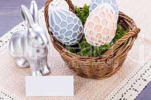 Easter still life with a silver bunny and eggs