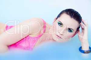 beautiful young woman with colorful makeup in water