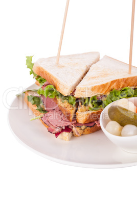 Delicious pastrami club sandwich and pickles