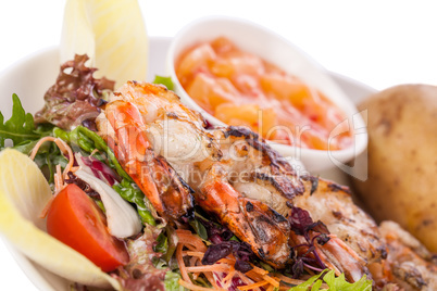 Grilled prawns with endive salad and jacket potato