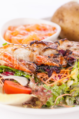 Grilled prawns with endive salad and jacket potato