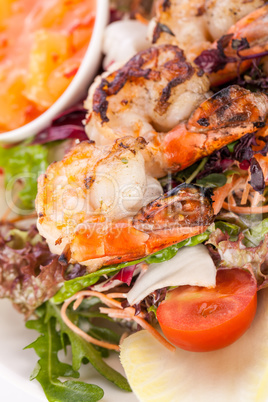 Grilled prawns with endive salad and jacket potato