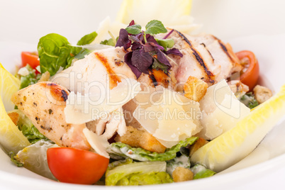 tasty fresh caesar salad with grilled chicken and parmesan