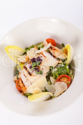 tasty fresh caesar salad with grilled chicken and parmesan