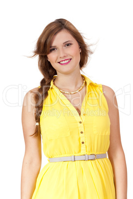 smiling young brunette woman in yellow dress isolated