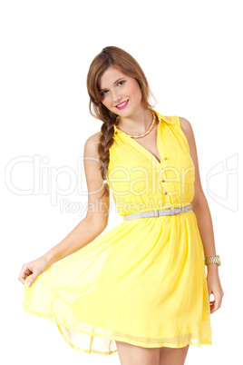 smiling young brunette woman in yellow dress isolated