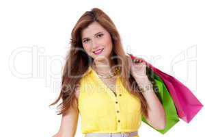 attractive young woman with colorful shopping bags isolated