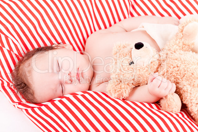 sleeping cute little baby on red and white stripes pillow