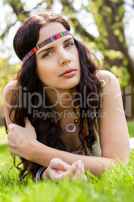Pretty young woman in a headband daydreaming
