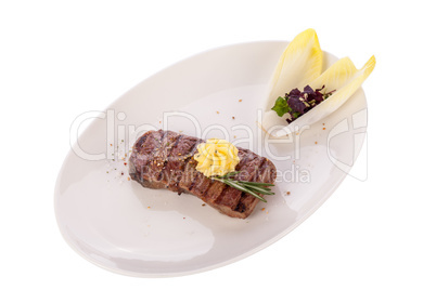 Grilled beef steak topped with butter and rosemary